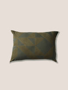 Decorative pillow with geometric pattern on a beige background