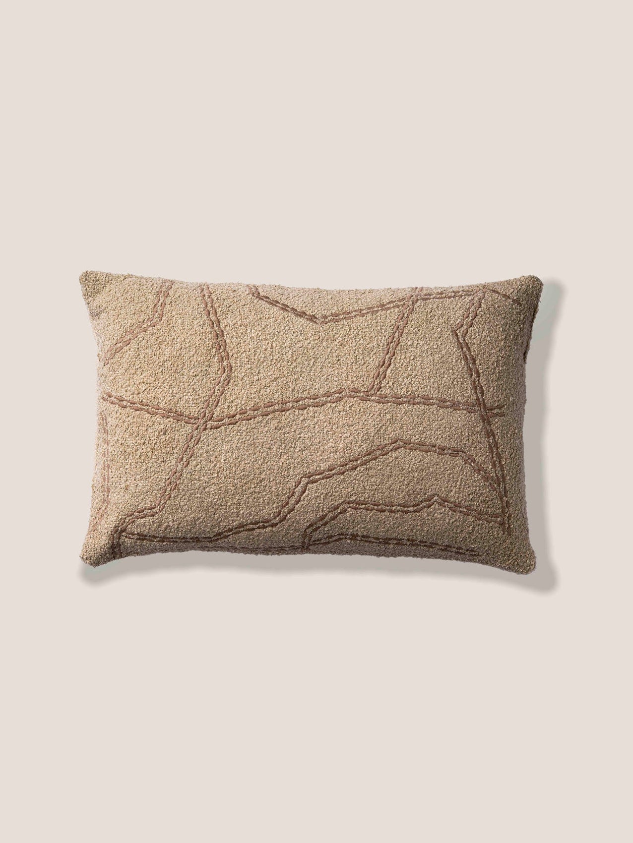 Textured rectangular pillow on a light beige background